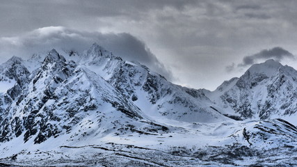 Power of snow cowered mountains in Norway, fog in the morning, may