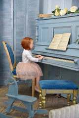 Cute little girl plays piano. Education, lesson