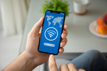 man hand holding phone with app search for free wi-fi