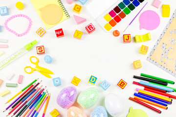 Child creativity concept flat lay. Various artistic tools for children on white desktop