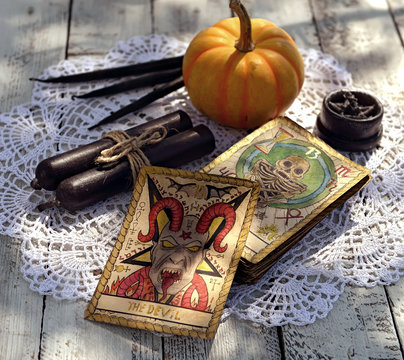 Tarot cards with pumpkin and black table on fortune teller table. Mystic background with ritual objects, occult, fortune telling and halloween concept