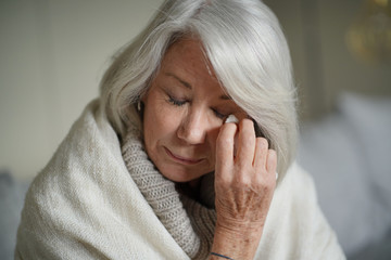   Senior woman at home feeling unwell