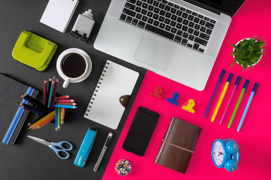 Office Supply Items, Laptop And Coffee On Black And Pink Background. Colorful And Vibrant Office Table Still Life.