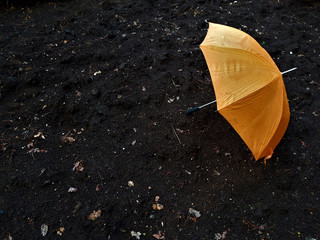 orange umbrella on the ground with dramatic tone