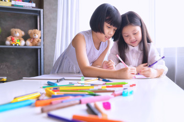 Group of cute little preschol kids drawing with colorful pencils