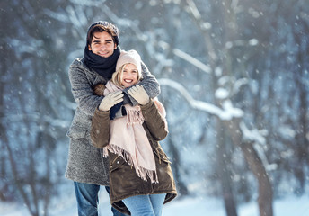 Fototapeta na wymiar Two young people enjoying in the snow
