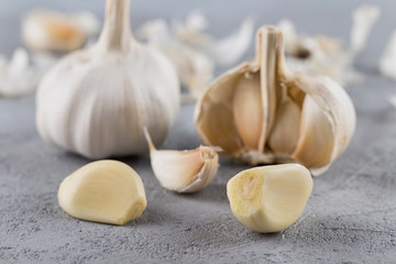 Garlic heads close-up on grey background. Condiment.