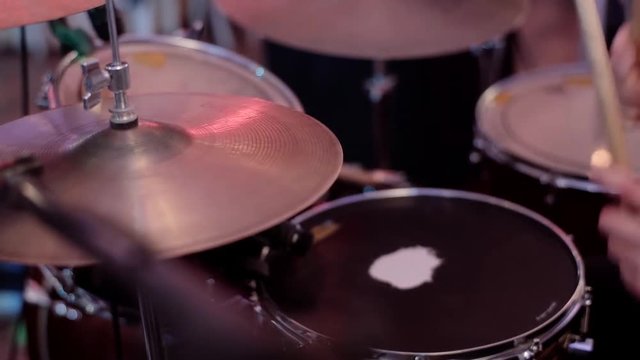 Drum sticks knock on different drums cymbals