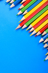Colored pencils background.Color pencils on blue background.Close up. Many different colored pencils on blue background.Colorful pencil .Colorfull