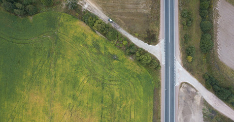 Aerial view of a road in a green field