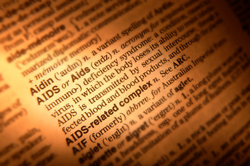 CLOSE UP OF DICTIONARY PAGE SHOWING DEFINITION OF THE WORD AIDS