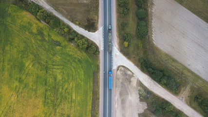 Aerial view of a road in a green field