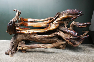 Abstract wooden bench made from tree trunk, isolated art object
