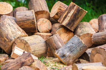 Firewood for heating in winter. Pile of cutting pine wood outdoors