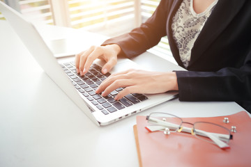 businesswoman hands with glasses using computer