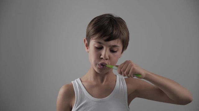 Lttle Boy Brushing His Teeth In Bathroom And Stop Becuse Of A Tooth Pain. Dental Problems