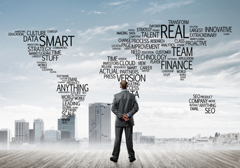 Motivation and inspiration concept with modern cityscape and businessman observing it