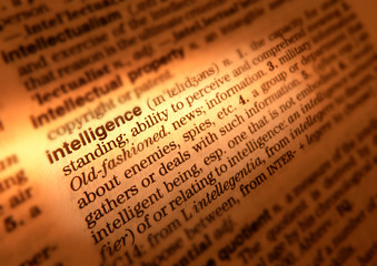 CLOSE UP OF DICTIONARY PAGE SHOWING DEFINITION OF THE WORD INTELLIGENCE