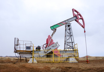 Fototapeta na wymiar Oil and gas industry. Panoramic of a pump jack and oil refinery.