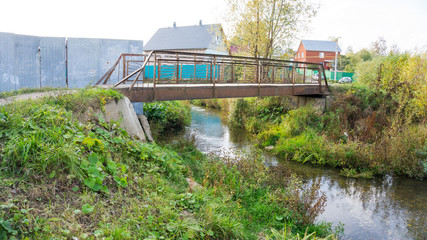 Fototapeta premium small iron bridge across the river