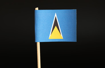 A official Flag of Saint Lucia on toothpick and on black background. The state located in caribbean...