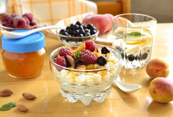 Cottage cheese with fresh berries and jam for breakfast