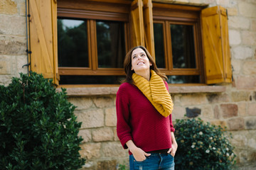 Young happy woman outside in autumn season. Tranquility and home safety concept.