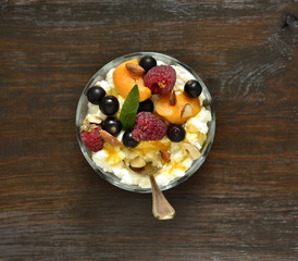 Cottage cheese with fresh berries and jam for breakfast, top view 