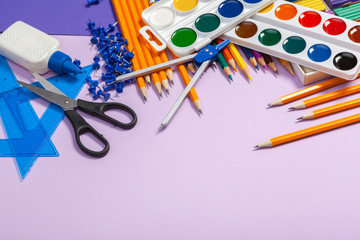 school supplies at abstract colorful background texture