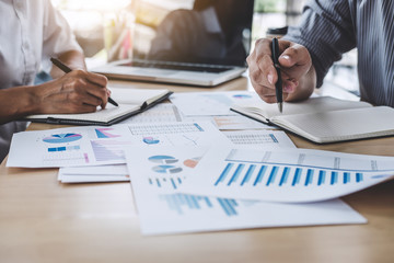 Business team colleagues discussing working analysis with financial data and marketing growth report graph in team, Meeting Talking Brainstorming Communication Concept