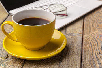 Workplace with office tools and gadgets. Cup of coffee on a table