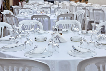 Plastic tables setting for an outdoor reception.