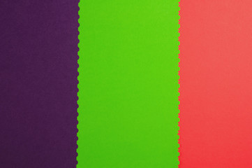Fototapeta premium Three blank papers red and green and violet color with figured cutted border. Top view. Education concept