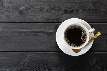 Top view of coffee cup on a wood background