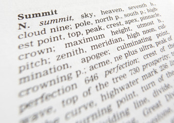 CLOSE UP OF DICTIONARY PAGE SHOWING DEFINITION OF THE WORD SUMMIT