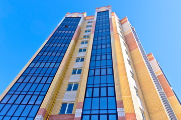 Naklejka premium Multi-storey building stretches to the sky.