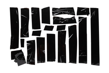 A collection of used black electrical tape pieces isolated on white background