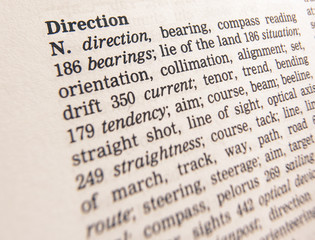 CLOSE UP OF DICTIONARY PAGE SHOWING DEFINITION OF THE WORD DIRECTION