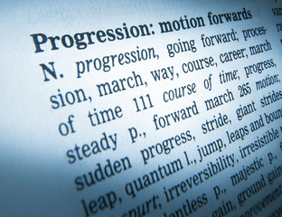 CLOSE UP OF DICTIONARY PAGE SHOWING DEFINITION OF THE WORD PROGRESSION