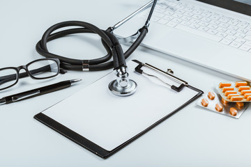 Stethoscope With Laptop on the table