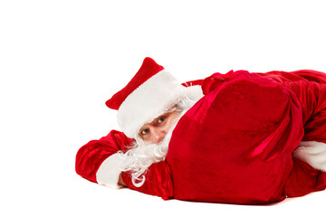 Santa Claus is lying with a bag of gifts.