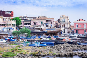 Fototapeta na wymiar Acitrezza harbor with fisher boats next to Cyclops islands, Catania, Sicily, Italy