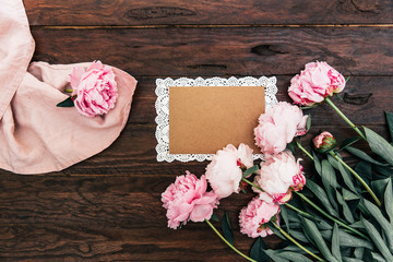 Stylish branding mockup blank greeting card or wedding invitation with pink peony flowers. Top view, flat lay