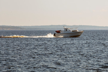 The boat moves on the forest lake