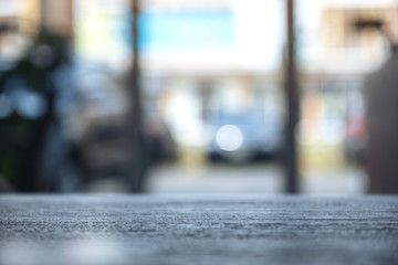 Fototapeta premium Wooden table in cafe with blur bokeh abstract vintage background