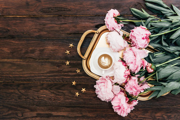 Morning concept. Coffee cup with pink peony on gold tray. Wedding, mothers day, valentines day