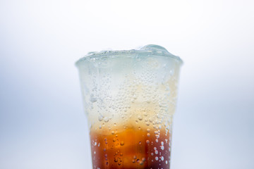 A glass of water, a close-up view of cold ice, a glass of soft drinks (soft drinks, alcohol, nectar) placed on a wooden table, managed by the client or eaten to refresh the body.