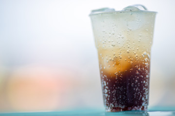 A glass of water, a close-up view of cold ice, a glass of soft drinks (soft drinks, alcohol, nectar) placed on a wooden table, managed by the client or eaten to refresh the body.