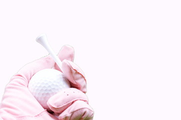 Hand of lady golfer is holding tee and golf ball 