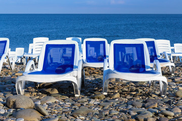 White and blue sun loungers by the sea